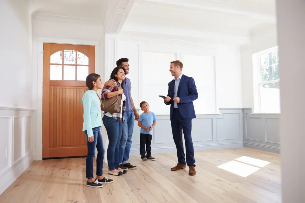 rental criteria checklist real estate agent welcoming family with children inside empty home during rental walkthrough