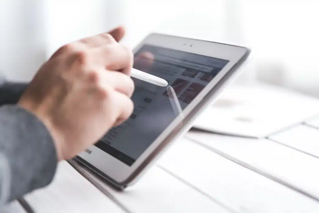 Apps for rent payment: Hand using a tablet with a stylus—mobile-friendly interface for managing payments and accounts.