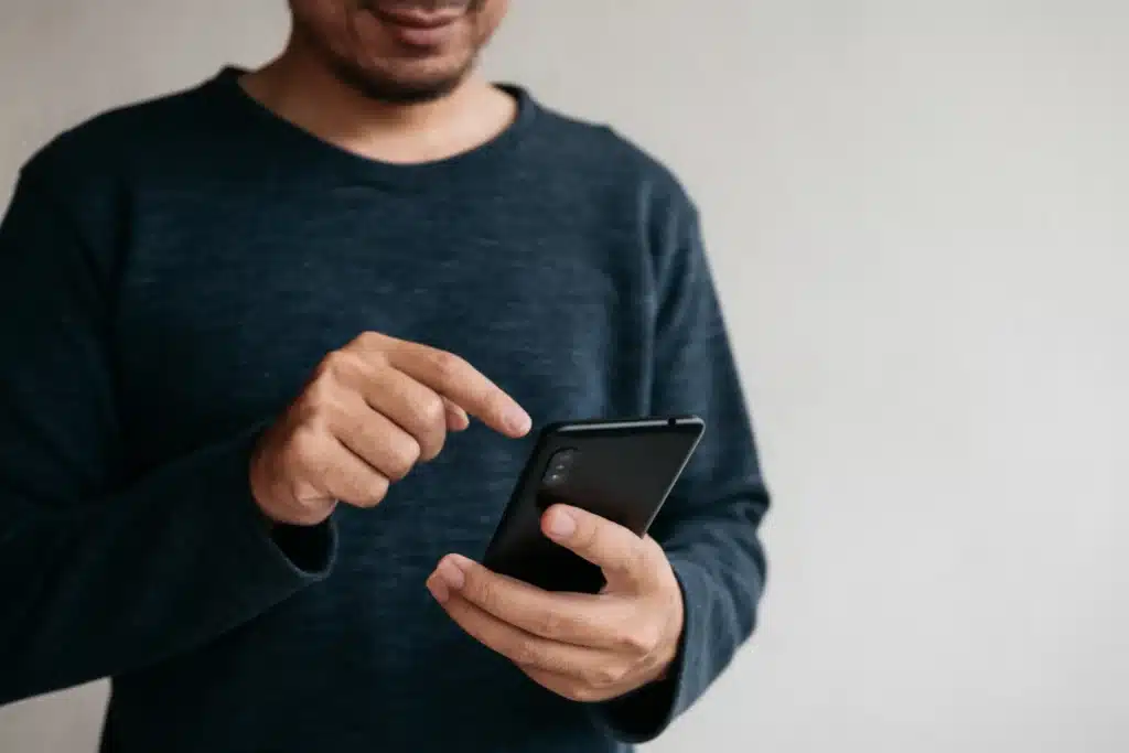 Best apps for landlords to collect rent illustrated by a person using a smartphone to manage rental payments.
