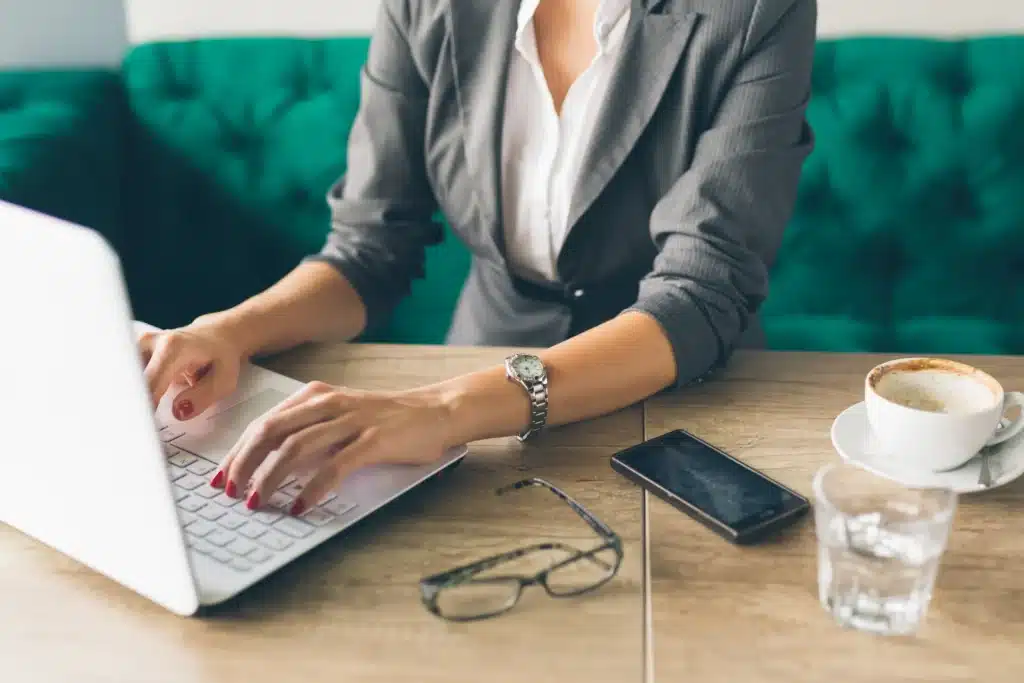 Electronic rent payments depicted as a professional using a laptop and smartphone to process rent transactions.