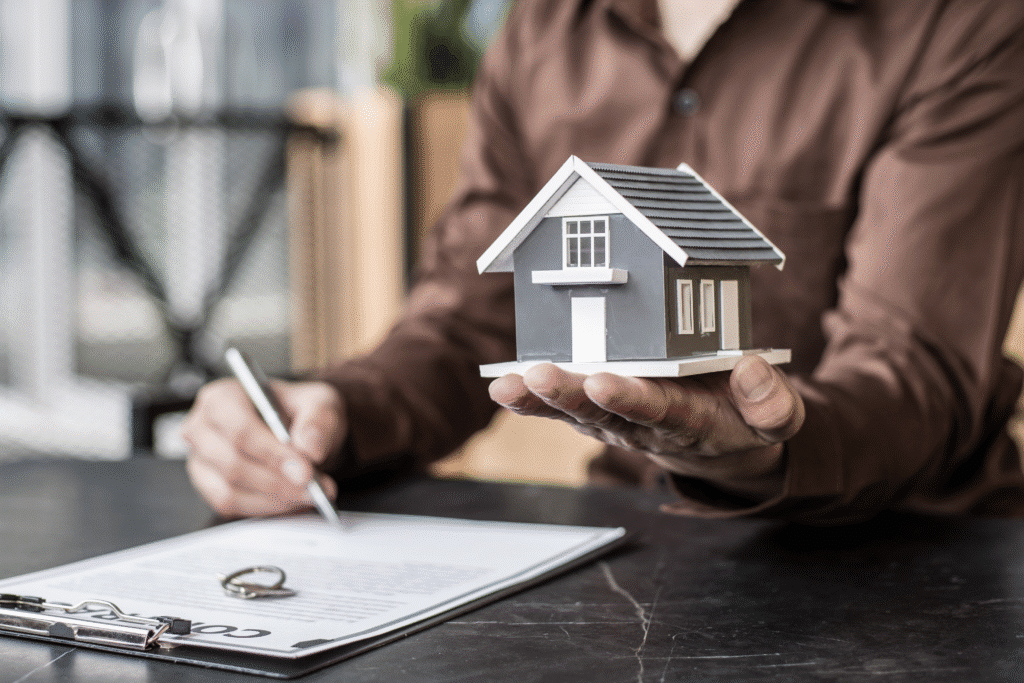 Preventive maintenance schedule illustrated by a person signing property documents while holding a model house.