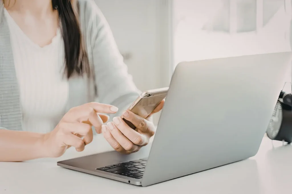 Rent collection software accessed on smartphone and laptop for managing tenant payments.