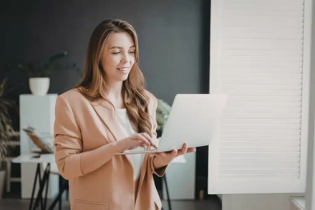 property manager using software to manage multiple properties on a laptop in an office