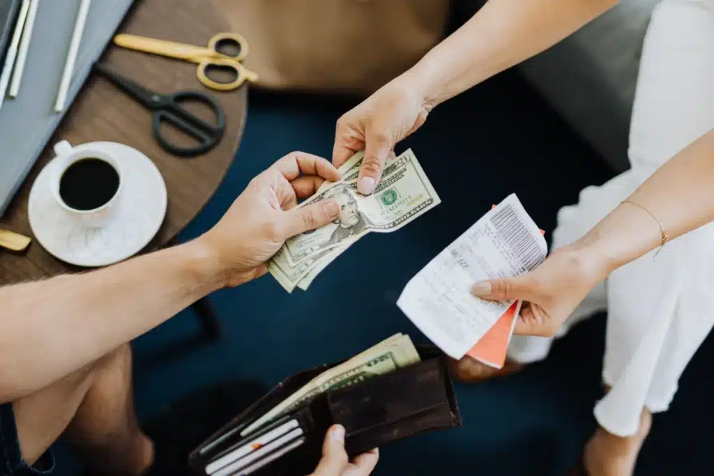 tenant handing cash as a rent payment method with receipt in hand